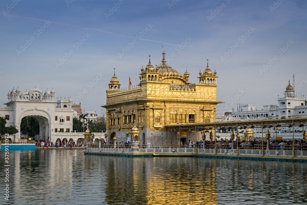 Evening view of the Golden temple in Amritsar, India with beautiful blue sky.