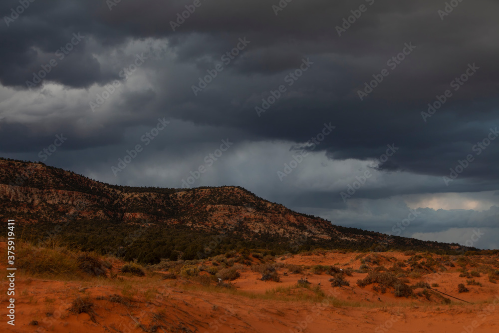 Stormy sky and clouds before sunset above the Coral Pink Sand Dunes State Park near Kanab, Utah, USA