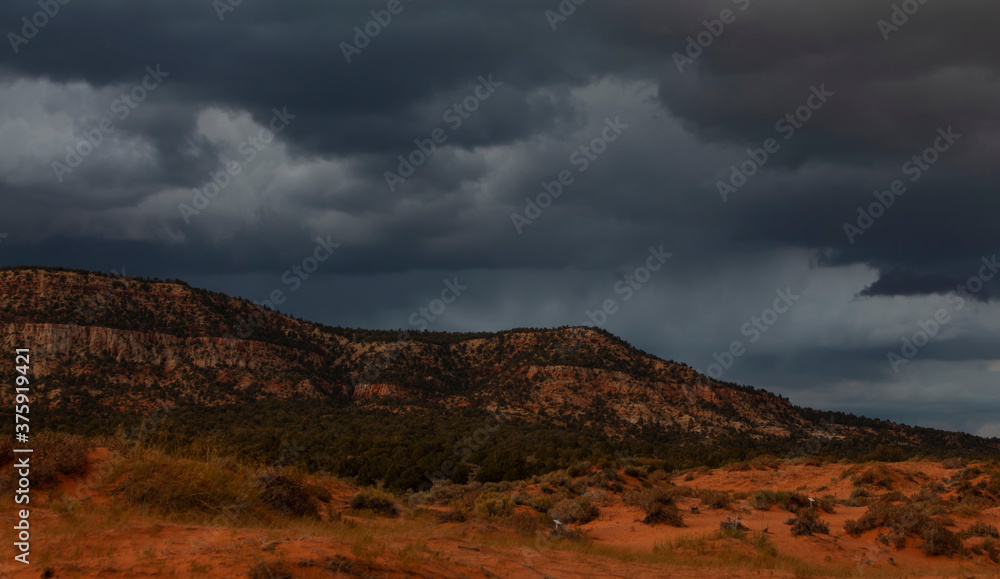 Stormy sky and clouds before sunset above the Coral Pink Sand Dunes State Park near Kanab, Utah, USA