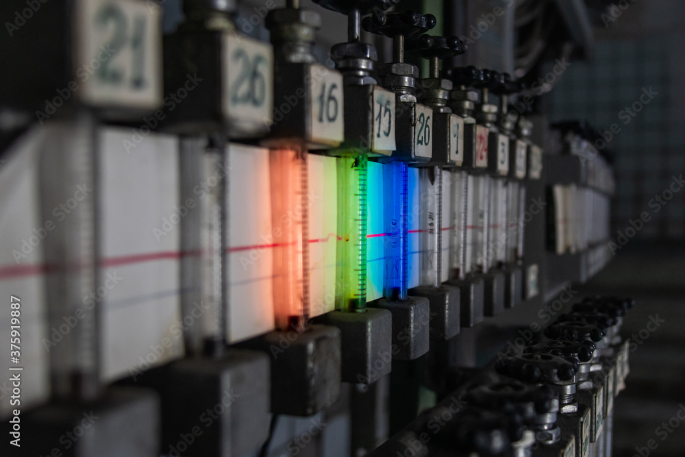 Close-up of multicolored rotameters in a dark technical room. Rotameters in the cable hub.