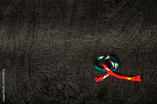Colored Thread on textured paper background  