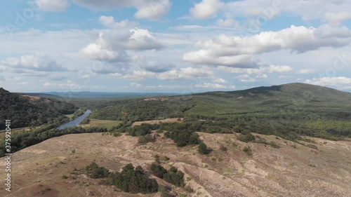 High sandy hill with green vegetation at the top. Shooting from a bird's eye view.