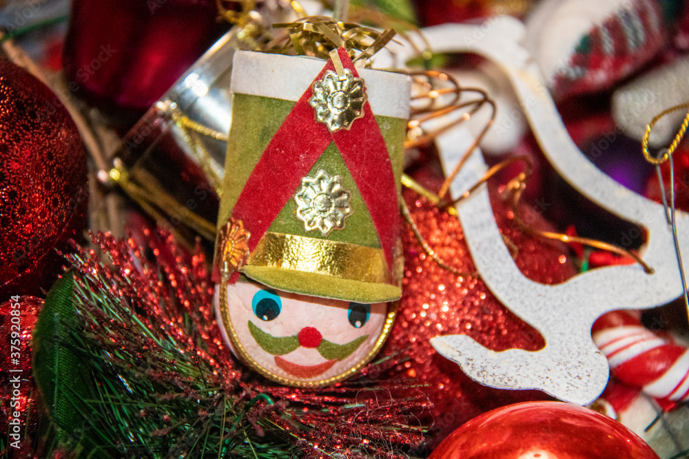 Retro toy soldier head Christmas decoration with background of other ornaments