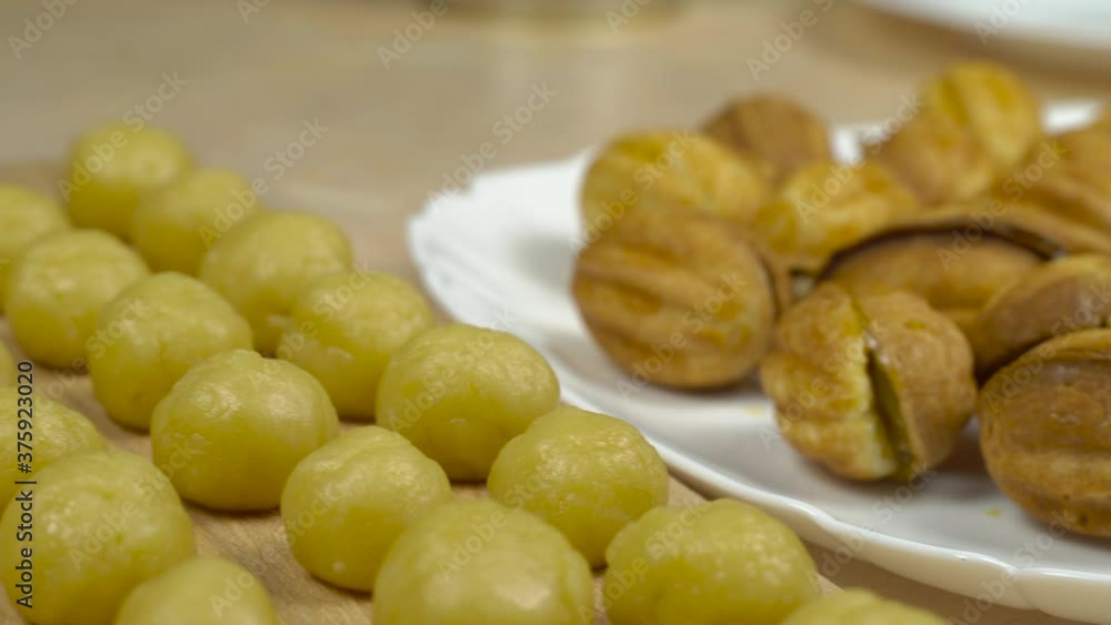A woman makes dessert nuts with condensed milk, fills them in the kitchen with condensed milk. Homemade cake. A woman makes dessert nuts with condensed milk, fills them in the kitchen with condensed milk. Homemade cake.
