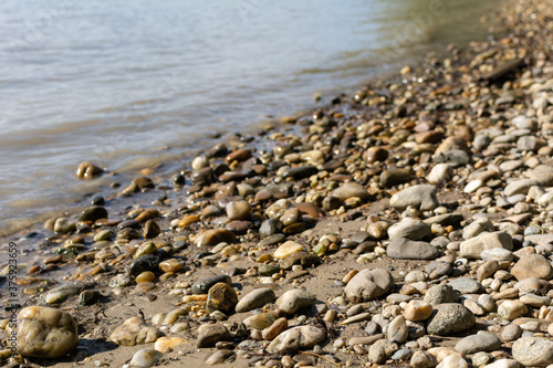 Pebble beach on the Danube River on a sunny summer day in Vienna, Austria