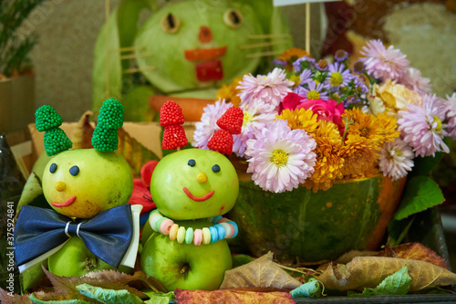 autumn children's creativity,children's art for the autumn holiday, caterpillar apples and flowers in a pumpkin