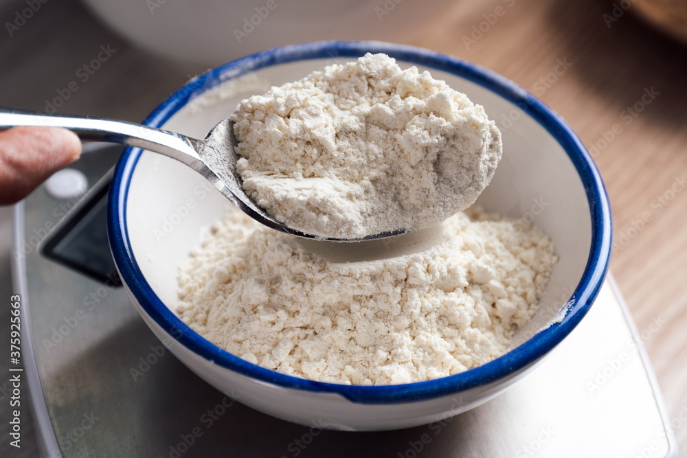 Flour in a spoon before weighing it