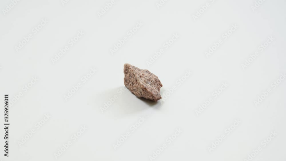 detail of pink sandstone over white background detail of pink sandstone over white background