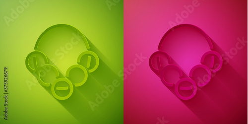 Paper cut Russian bagels on a rope icon isolated on green and pink background. Paper art style. Vector.