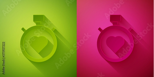 Paper cut Heart in the center stopwatch icon isolated on green and pink background. Valentines day. Paper art style. Vector.