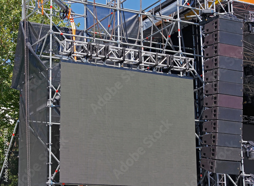 speakers hanging for an outdoor concert photo