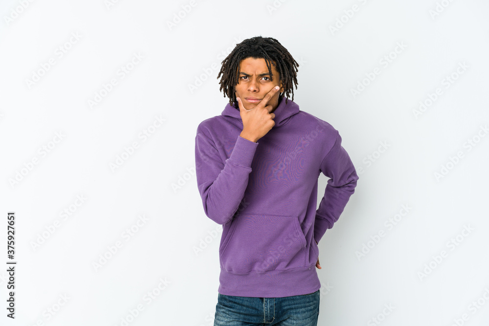 Young african american rasta man contemplating, planning a strategy, thinking about the way of a business. Young african american rasta man contemplating, planning a strategy, thinking about the way of a business.
