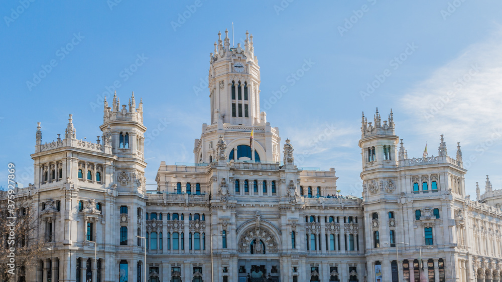 Exterior facade of the post office building in Plaza Cibeles in Madrid Spain on sunny day with a blue sky