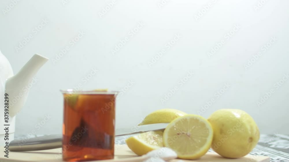 Preparing green tea with lemon wedges. On wooden cutting board. Preparing green tea with lemon wedges. On wooden cutting board.