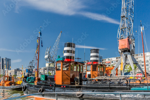 Cargo ships anchored in the Wijnhaven harbor in the center of Rotterdam on a wonderful sunny day with a blue sky in the Netherlands Holland photo