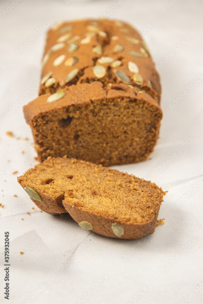 Close up slices of pumpkin bread with pumpkin puree, cinnamon, nutmeg and seeds, placed on white background. Close up slices of pumpkin bread with pumpkin puree, cinnamon, nutmeg and seeds, placed on white background.
