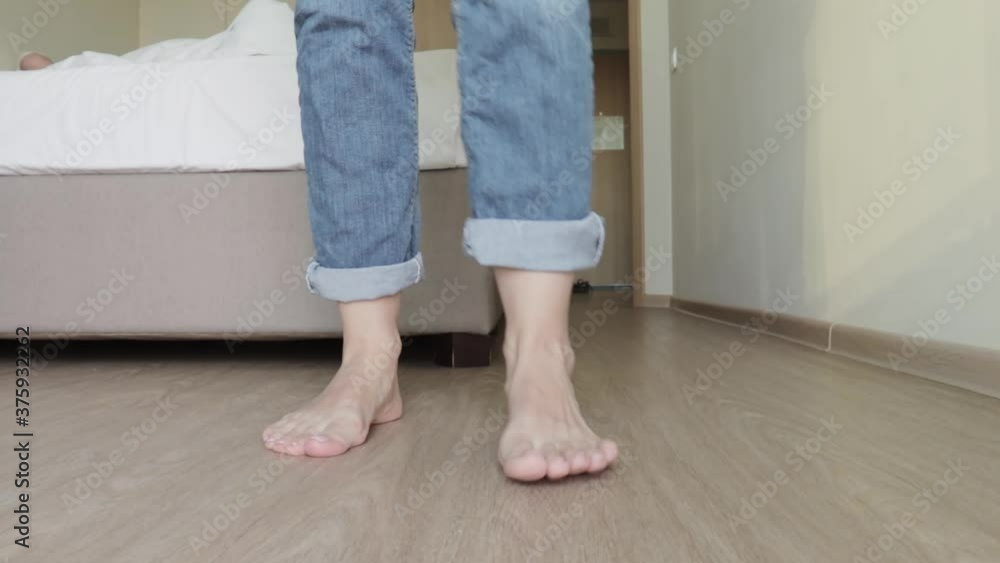 Woman taking off her clothe sin order to go to bed, bare feet close up, clothes falling down to the floor Woman taking off her clothe sin order to go to bed, bare feet close up, clothes falling down to the floor