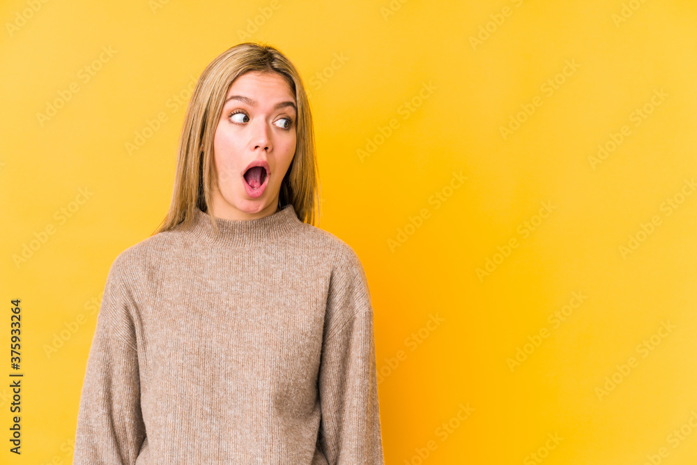 Young blonde caucasian woman isolated being shocked because of something she has seen. Young blonde caucasian woman isolated being shocked because of something she has seen.