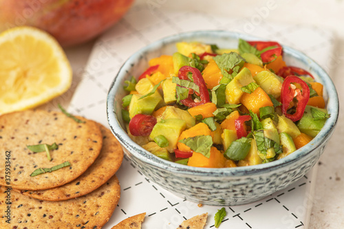 Fresh salad with mango, red pepper, avocado and mint