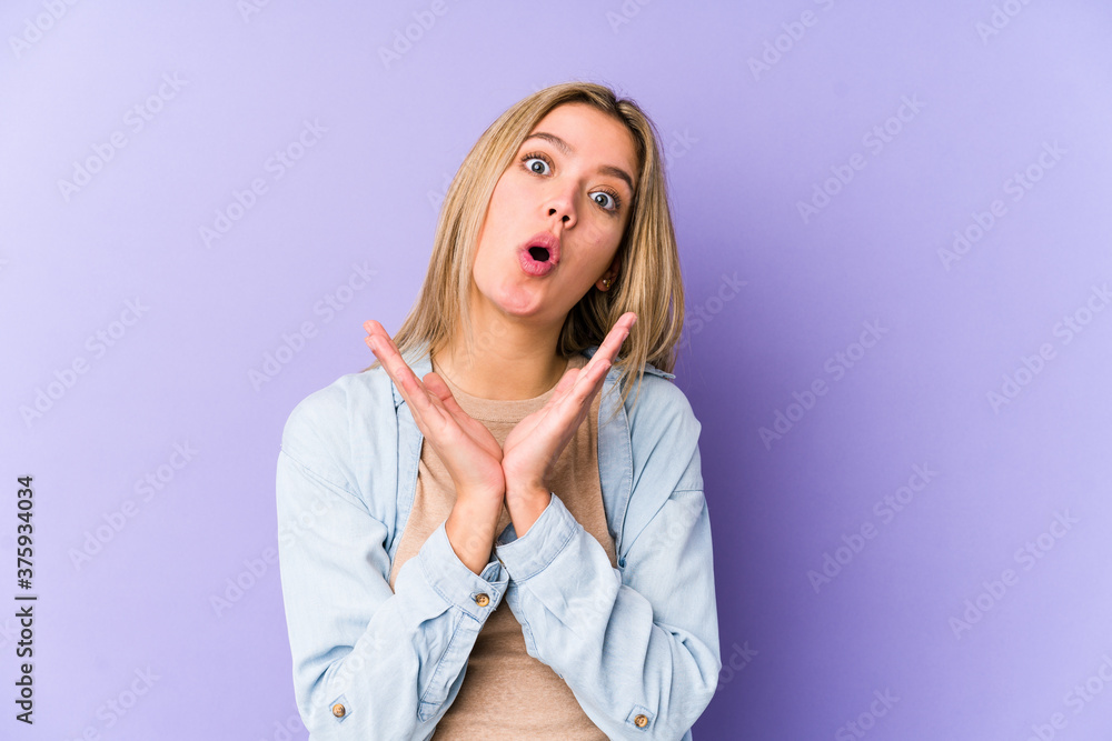 Young blonde caucasian woman isolated surprised and shocked. Young blonde caucasian woman isolated surprised and shocked.