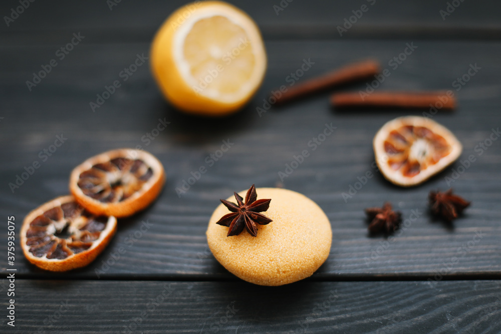 Natural handmade soap with dried slices of oranges and cinnamon on a dark background. Concept of Spa, body and skin care. Natural handmade soap with dried slices of oranges and cinnamon on a dark background. Concept of Spa, body and skin care.