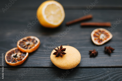 Natural handmade soap with dried slices of oranges and cinnamon on a dark background. Concept of Spa, body and skin care. 