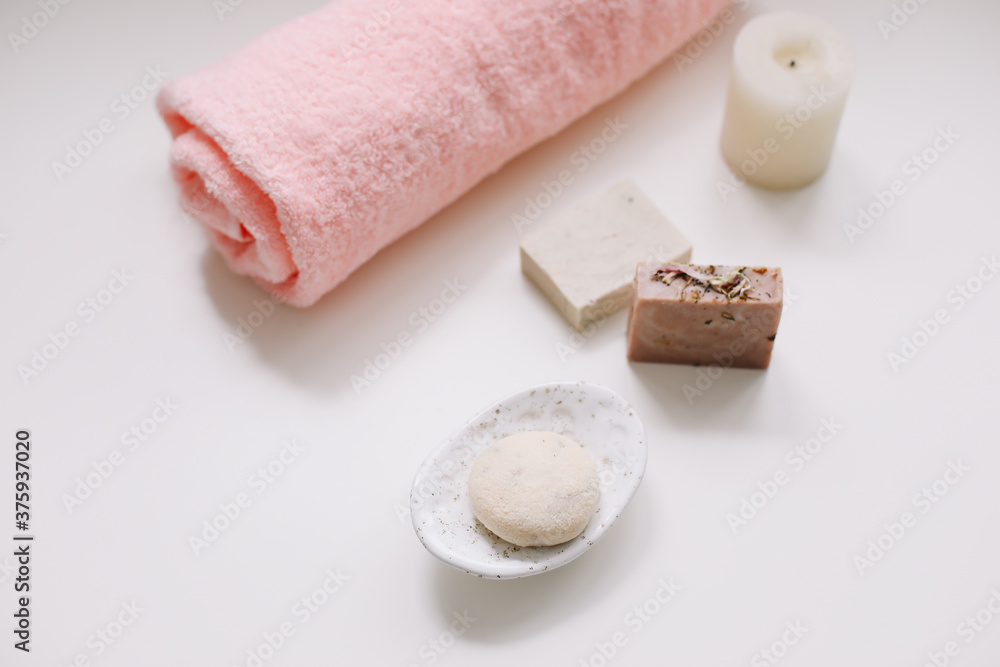 Spa set. Bar of handmade soap, candle and towel. Accessories for personal hygiene. Decor for bathroom interior Spa set. Bar of handmade soap, candle and towel. Accessories for personal hygiene. Decor for bathroom interior