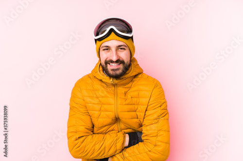 Young skier man isolated laughing and having fun.