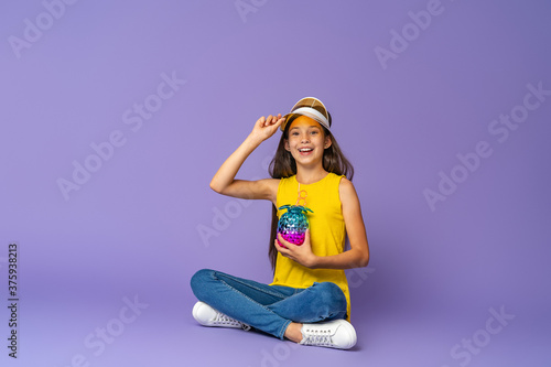 stylish brunette girl in fashionable clothes and a transparent yellow visor © skif