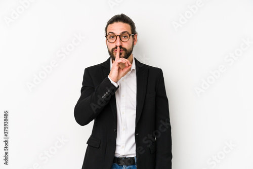 Young caucasian business man isolated on a white background keeping a secret or asking for silence.