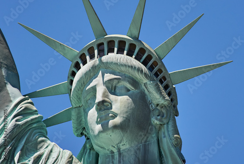 New York, USA, April 22, 2020: Statue of Liberty in New York close up. Blue sky in Manhattan photo