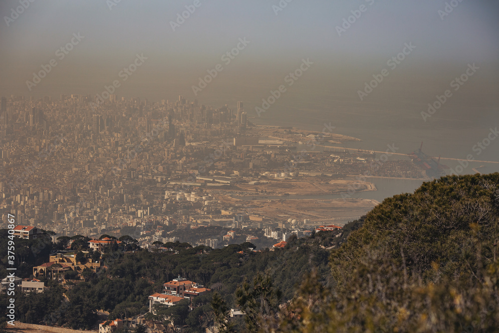 Smog dome and dust during sunrise in a very polluted city. Panoramic View of Beirut (Lebanon).