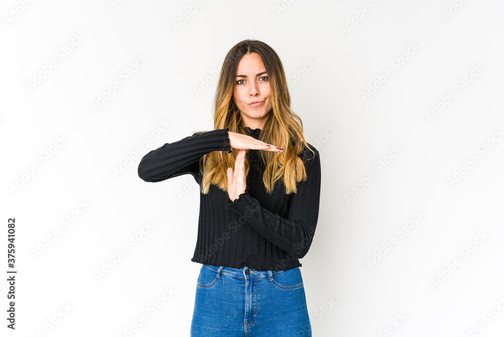 Young caucasian woman isolated on white background showing a timeout gesture. Young caucasian woman isolated on white background showing a timeout gesture.