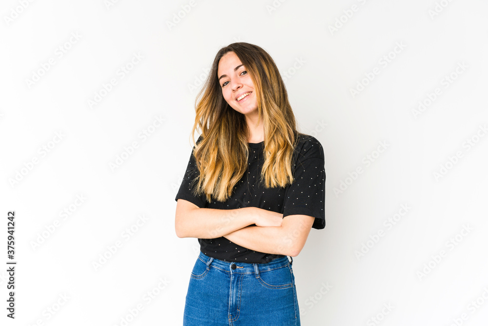 Young caucasian woman isolated on white background who feels confident, crossing arms with determination. Young caucasian woman isolated on white background who feels confident, crossing arms with determination.
