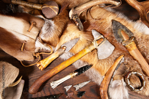 Stone Age Tools on wooden Background photo