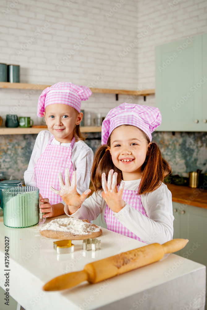 girls in the kitchen knead gingerbread dough. girls in the kitchen knead gingerbread dough.