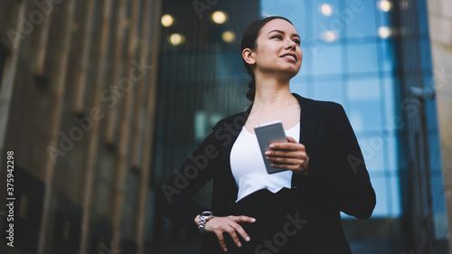 Smiling businesswoman with smartphone in hand