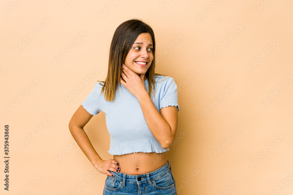 Young woman isolated on beige background touching back of head, thinking and making a choice. Young woman isolated on beige background touching back of head, thinking and making a choice.