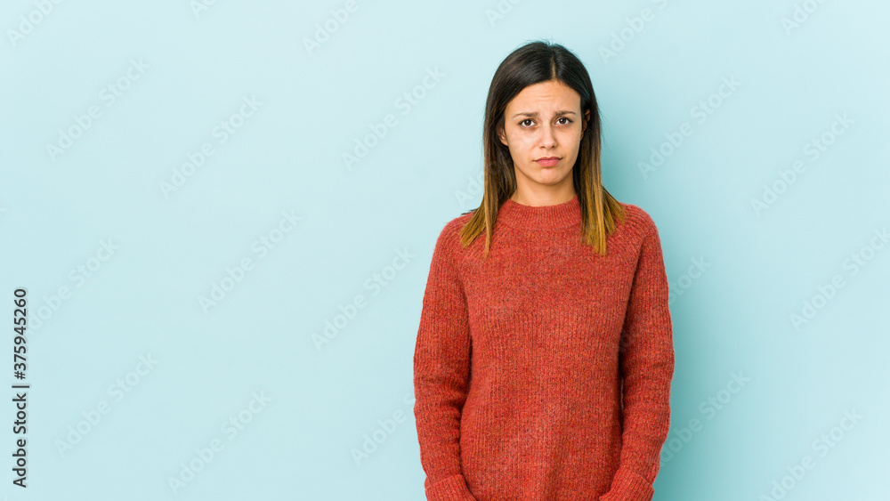Fototapeta premium Young woman isolated on blue background sad, serious face, feeling miserable and displeased.