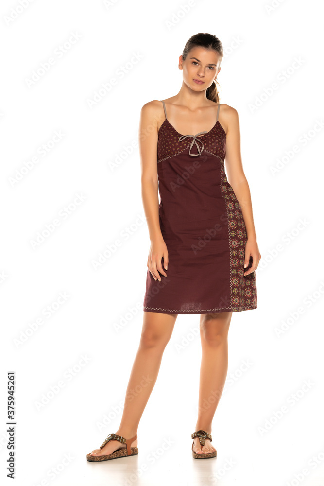 Woman model in dress posing in studio, isolated on white. Woman model in dress posing in studio, isolated on white.