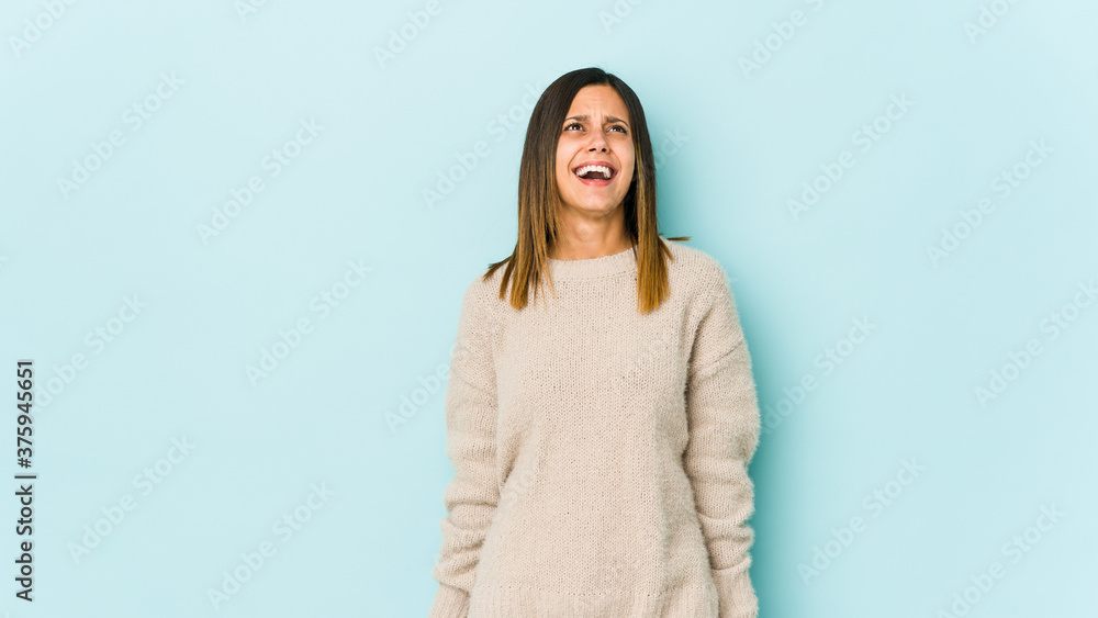 Young woman isolated on blue background shouting very angry, rage concept, frustrated. Young woman isolated on blue background shouting very angry, rage concept, frustrated.