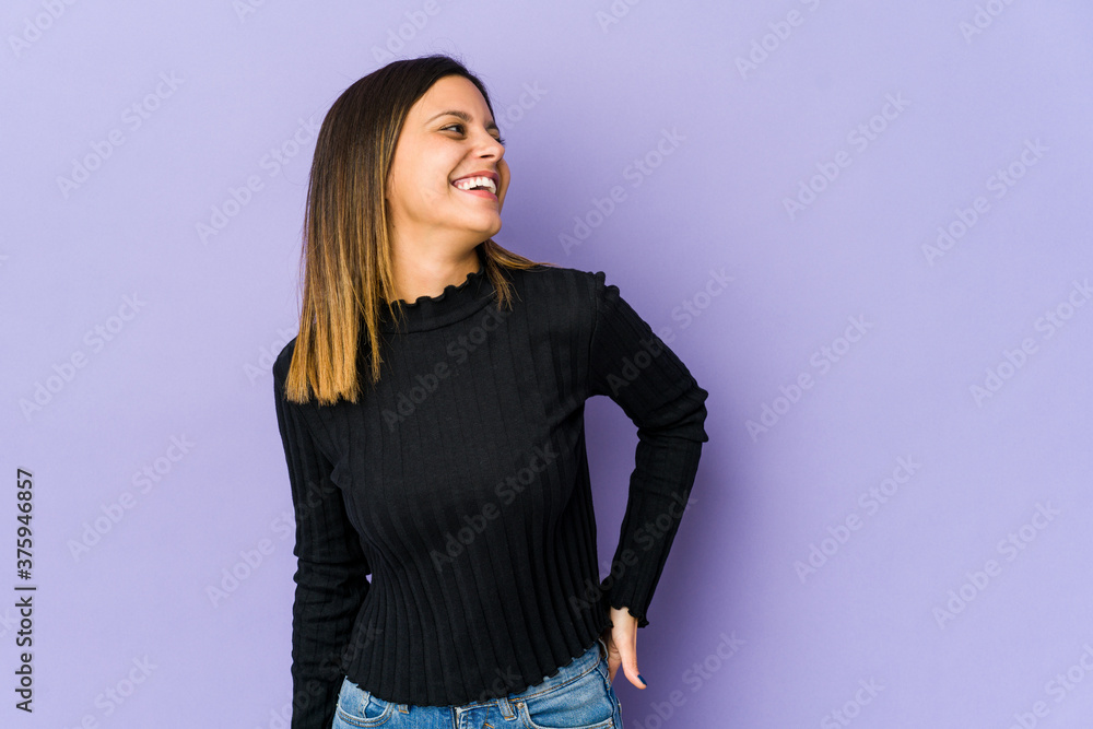 Young woman isolated on purple background relaxed and happy laughing, neck stretched showing teeth. Young woman isolated on purple background relaxed and happy laughing, neck stretched showing teeth.