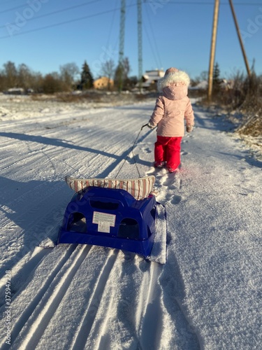little girl on a sled
