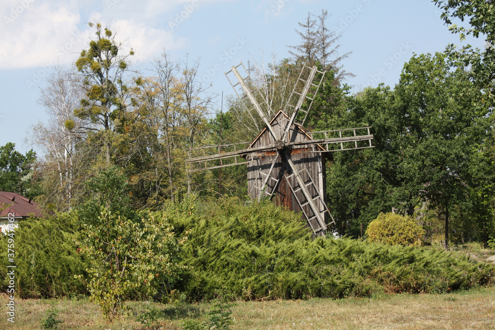 Rural summer landscape with an old mill.