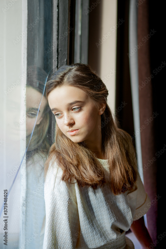 pensive girl's portrait against the background of broken window glass pensive girl's portrait against the background of broken window glass