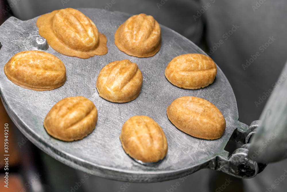 Ready-made, baked cookie parts Nut on a round shape for baking close-up