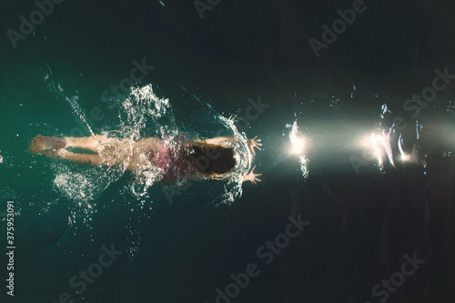 Overhead view of girl swimming in lake