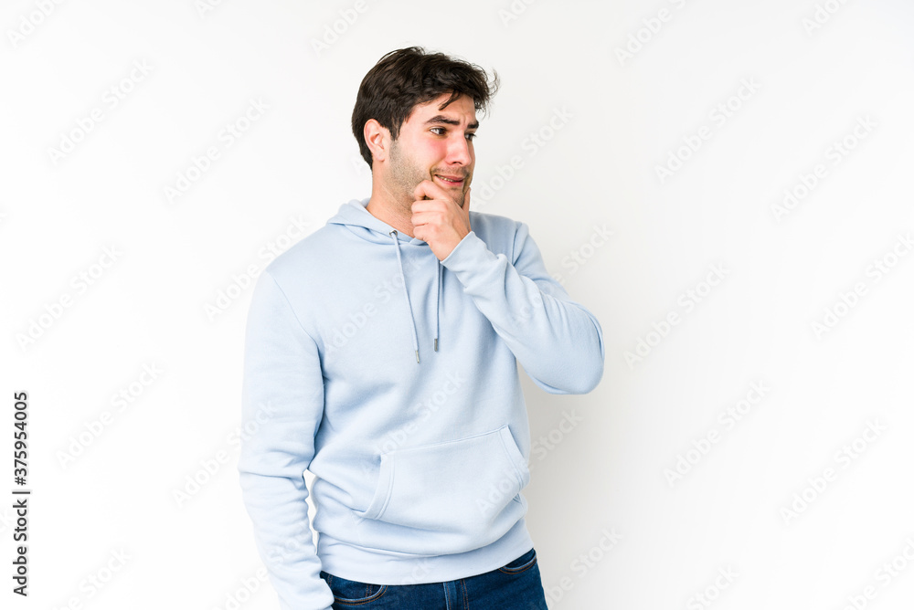 Young man isolated on white background touching back of head, thinking and making a choice. Young man isolated on white background touching back of head, thinking and making a choice.