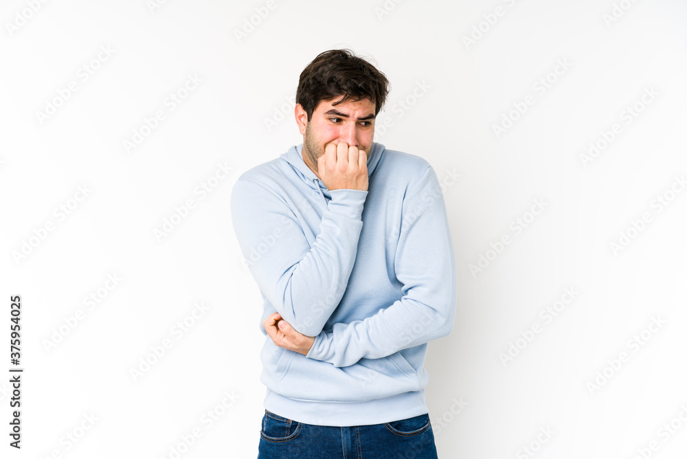 Young man isolated on white background biting fingernails, nervous and very anxious. Young man isolated on white background biting fingernails, nervous and very anxious.