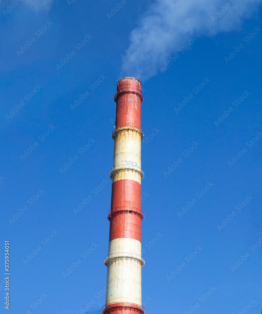 Rusty smoke pipe of factory against blue sky White smoke from chimney of industrial pipe. Rusty smoke pipe of factory against blue sky White smoke from chimney of industrial pipe.